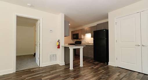 affordable section 8 stone mountain a kitchen with a black refrigerator and a table