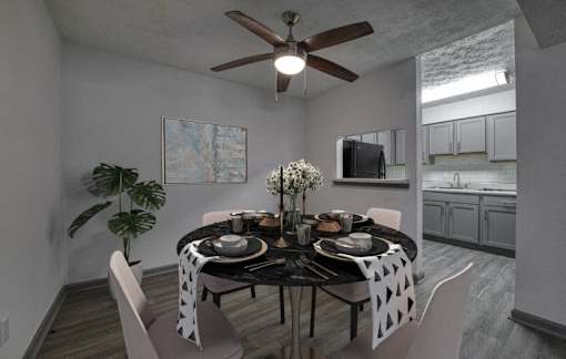 a dining room with a table and a ceiling fan