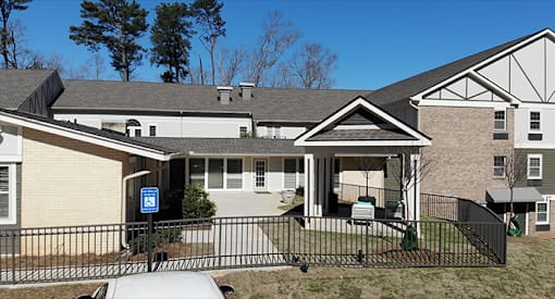 a home with a ramp and a fence in front of it