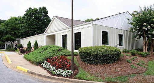 a white house with a garden in front of it