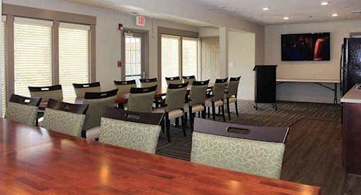 a conference room with a long wooden table and chairs