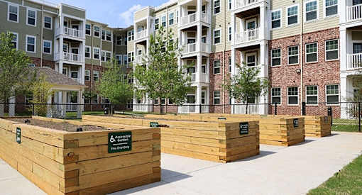 a wooden retaining wall in front of an apartment building
