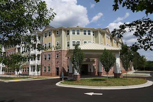 an apartment building with a roundabout in front of it