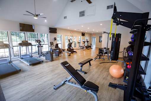 decatur luxury living a gym with exercise equipment and windows in a building