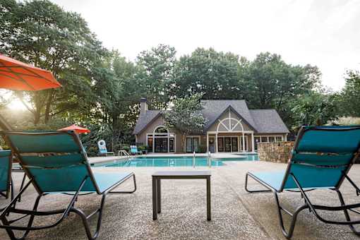 decatur luxury living a pool with chairs and a house in the background