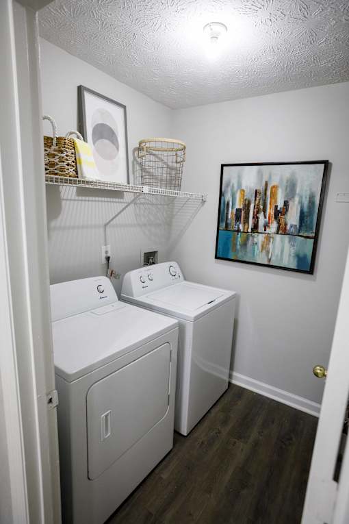 decatur luxury living a white laundry room with two washes and a dryer