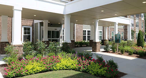 a garden in front of a building with columns