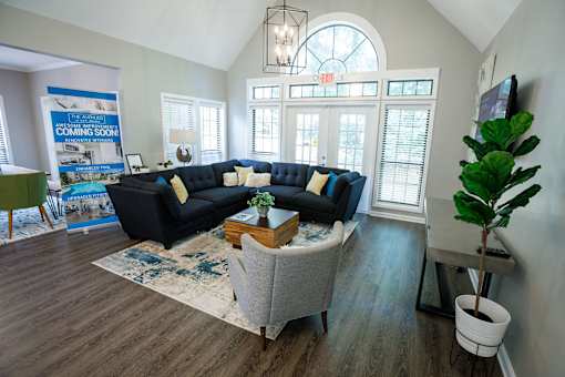 a living room with blue couches and a coffee table
