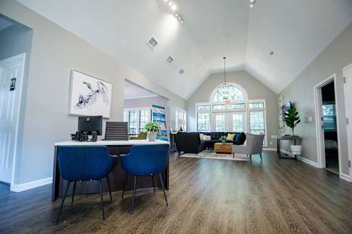 a dining room and living room with a table and chairs