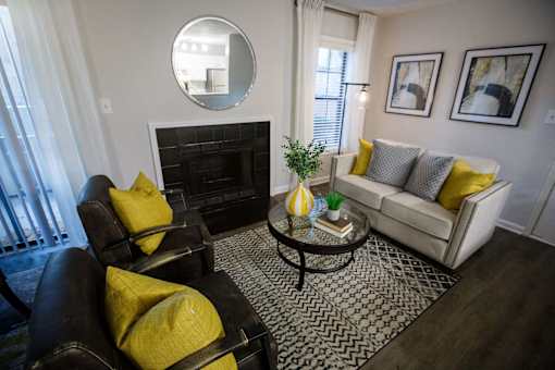 a living room with yellow pillows and a couch