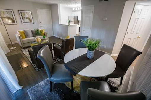 a dining room and living room with a table and chairs