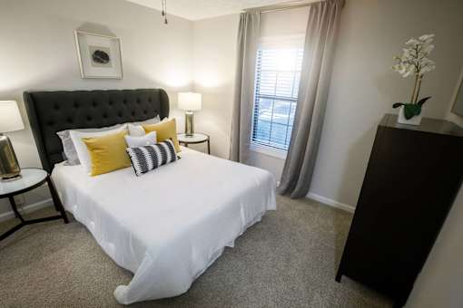 a bedroom with a large white bed and a window