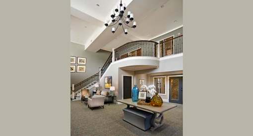 a living room with a staircase and a table