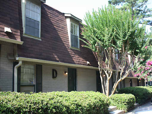 A house with a dark brown roof and white trim.