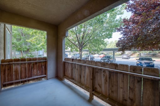 Private corner patio access from dinning area with 4 foot fence and stucco ceiling concrete floor