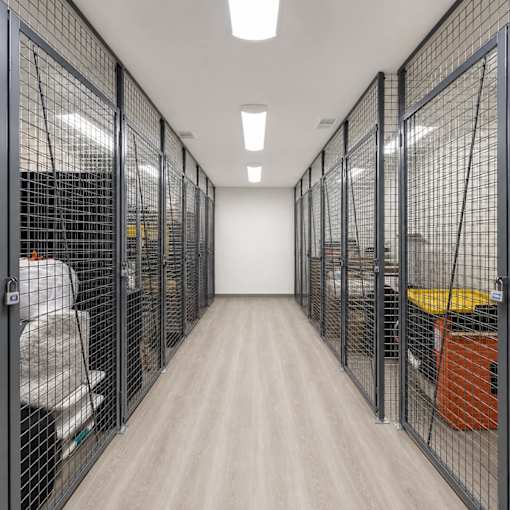 A long hallway with metal fencing on both sides.