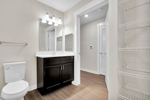 A white toilet sits next to a sink in a bathroom.
