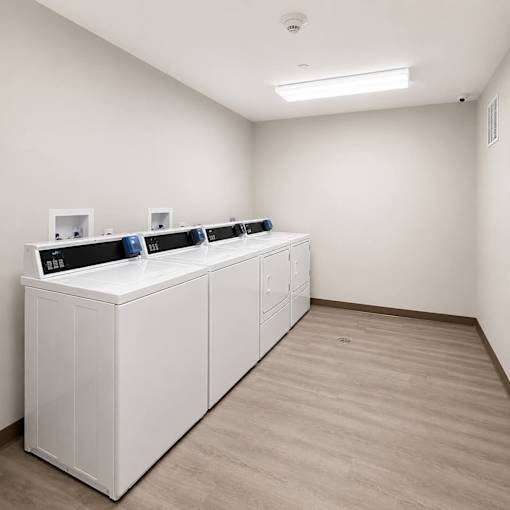 A white medical device is on a white cabinet in a white room.
