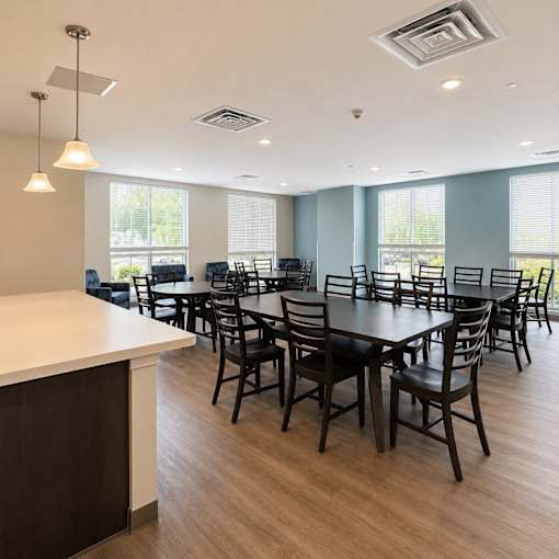 A large conference room with a long table and chairs.