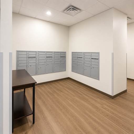 A room with a brown table and grey lockers.