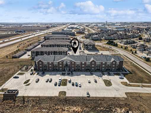 A large building with a parking lot in front of it.