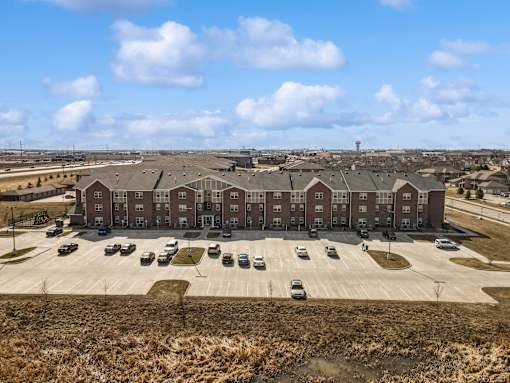 A large building with a parking lot in front of it.