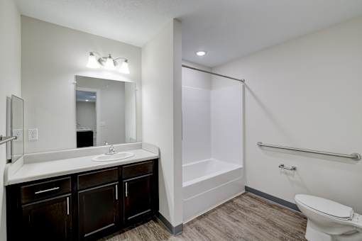 A bathroom with a white sink and a white toilet.