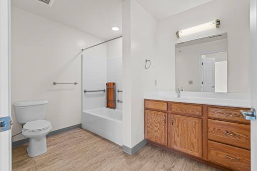 A white bathroom with a toilet, sink, and bathtub.