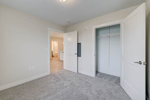 A white door is open to a hallway.