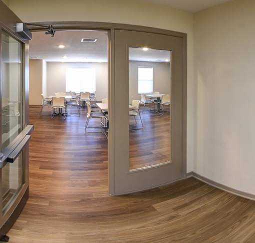 A room with a glass door and a wooden floor.