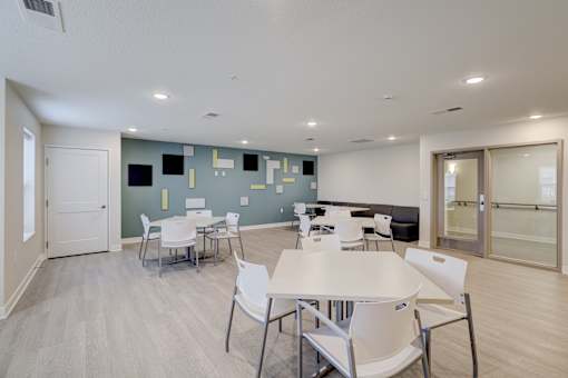 A conference room with a white table and chairs.