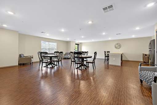 A living room with a dining table and chairs.