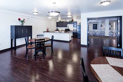 A kitchen with a dining table and chairs.