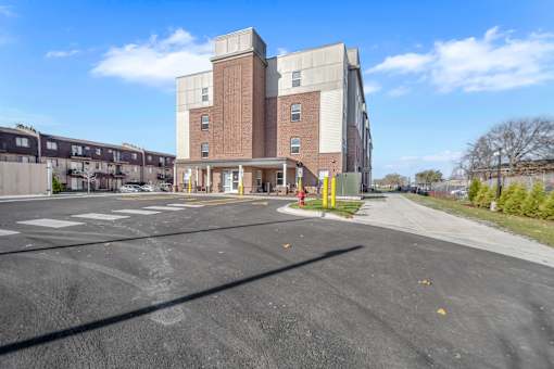 A large building with a parking lot in front of it.
