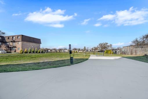 A long, straight pathway leads through a grassy area.