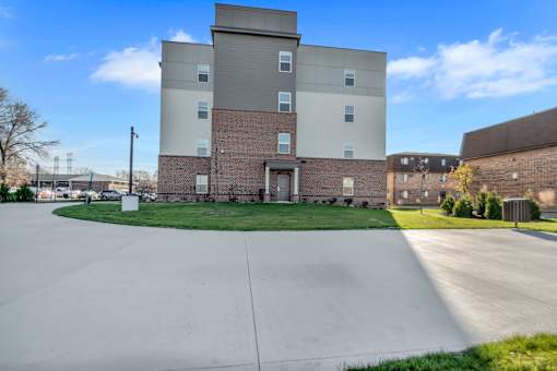 A large building with a parking lot in front.