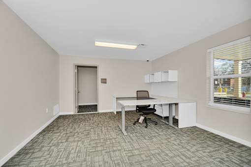 A room with a desk and a chair.