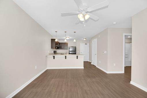 A room with a ceiling fan and light fixture.
