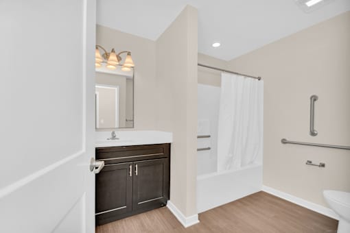 A bathroom with a white tub, sink, and toilet.