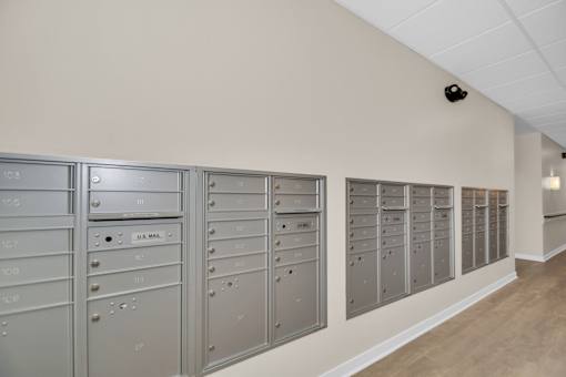 A wall of mailboxes in a room.