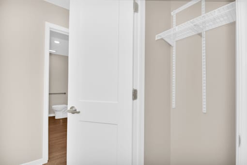 A white door is open to a bathroom.