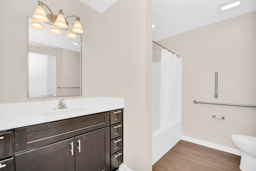 A bathroom with a white counter top and a white toilet.