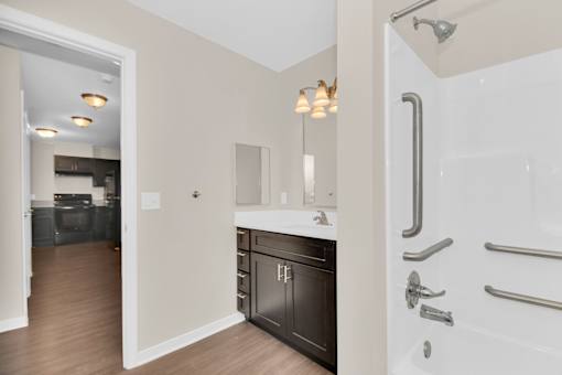A bathroom with a white tub and a walk-in shower.