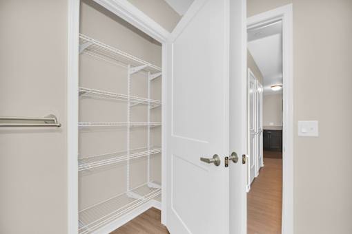 A white door is open to a hallway.