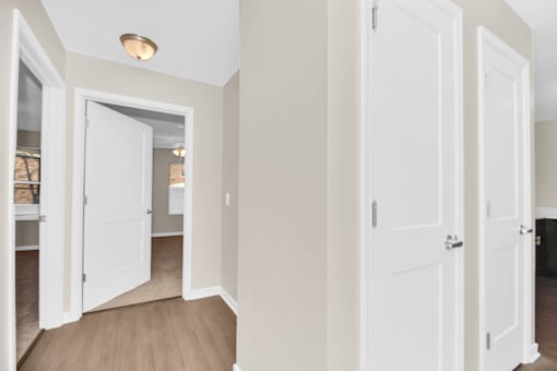 A white door is open to a hallway.