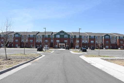 A long road with apartment buildings on both sides.