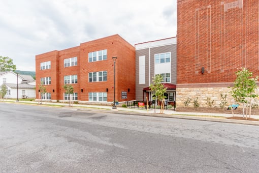 a red brick building with a street in front of it