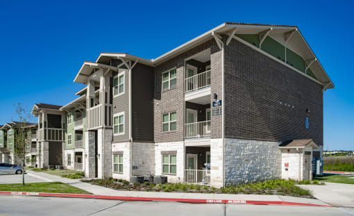 an apartment building with a street in front of it