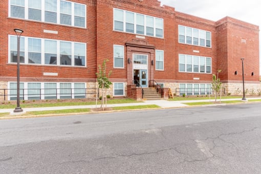 a large brick building with a street in front of it