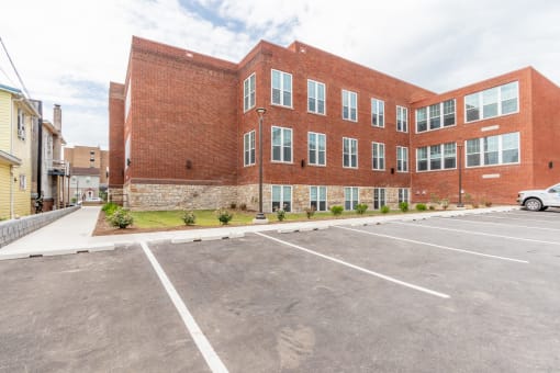 a large brick building with a parking lot in front of it